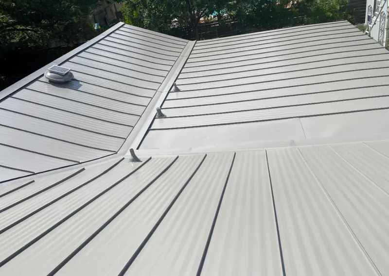 Solar attic fan installed on a metal roof for Roof Ventilation in Hastings